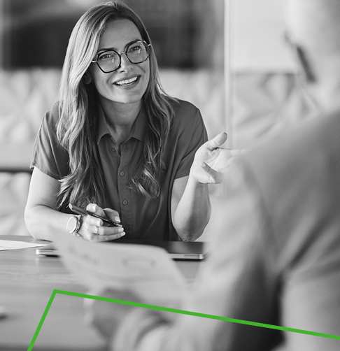 Woman and man dressed in outdoor gear, enjoying a hike in the woods.